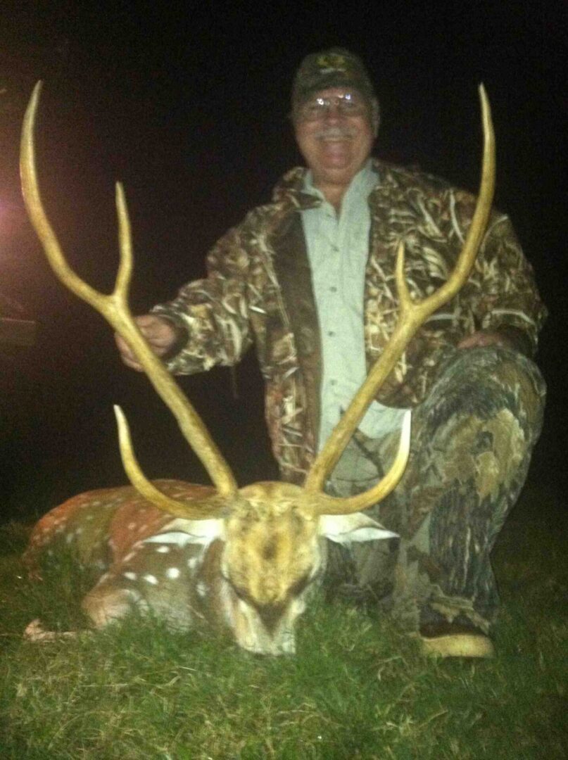 A Man Holding a Deer After a Hunt